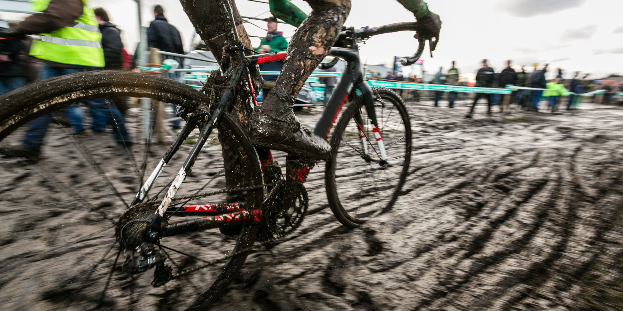 Cyclocross Fahrer fährt über eine Schlamm-Strecke