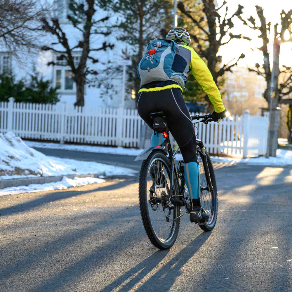 Fahrradfahrer fährt im Winter auf Straße